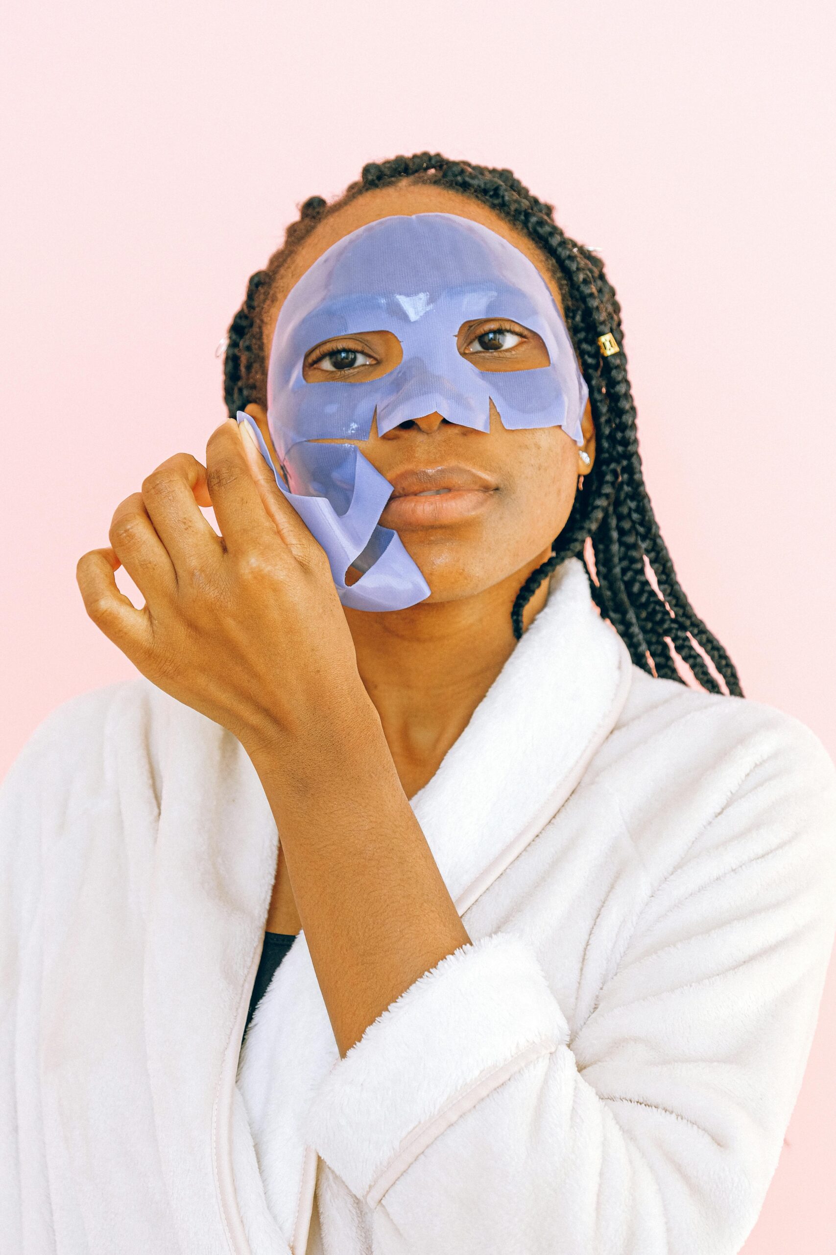 Portrait of a woman wearing a blue face mask, emphasizing skincare and beauty routines.