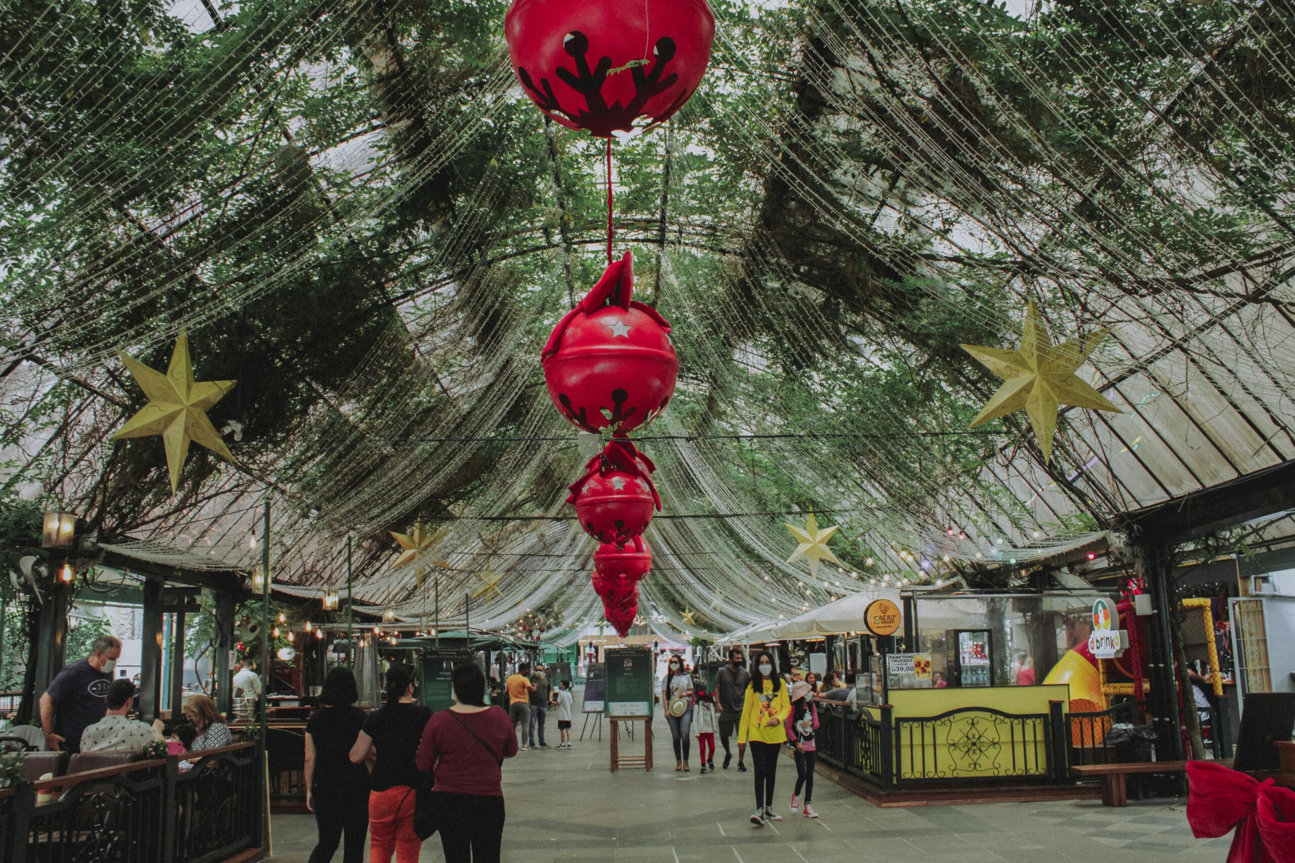Indoor market in Gramado with festive red lanterns and stars celebrating the holiday season.