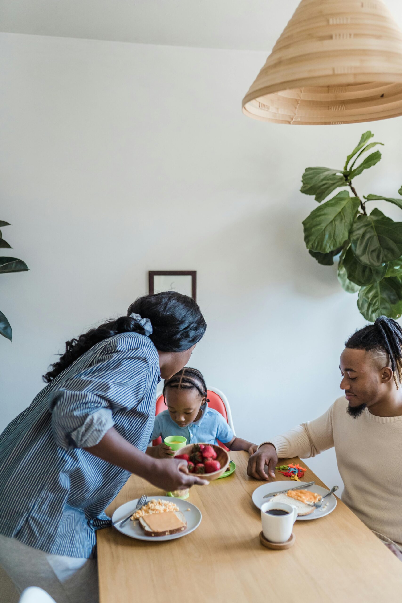 A loving family shares a breakfast meal at home, fostering bonds and togetherness.