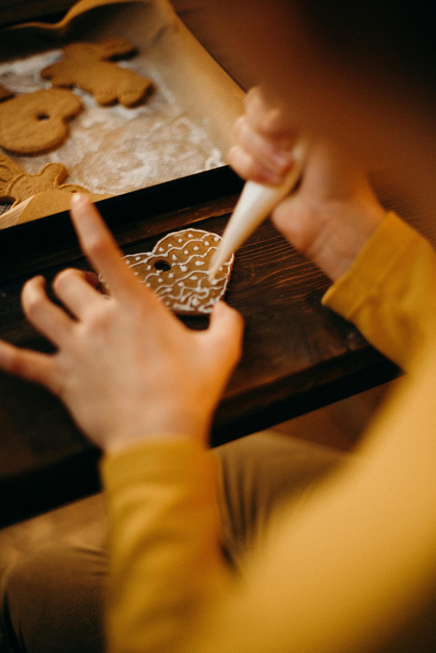 Close-up of gingerbread cookie decoration with icing for festive holiday preparation.