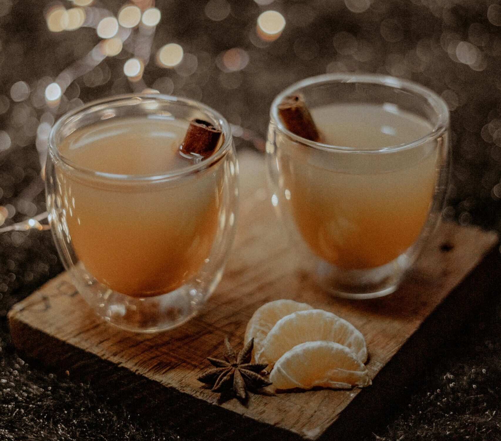 Warm spiced tea with citrus slices and star anise, perfect for a cozy winter evening.
