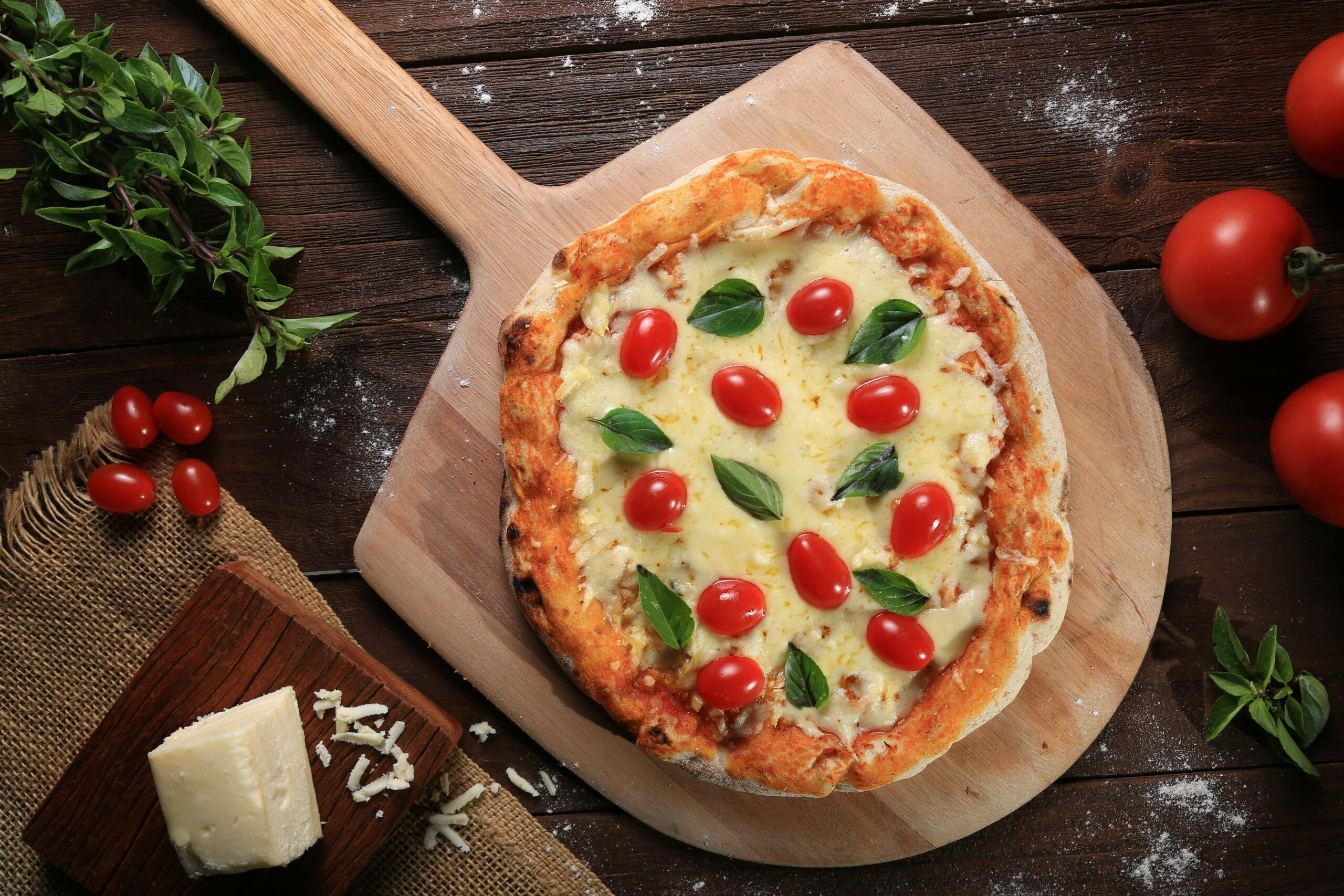 A delicious Italian pizza topped with fresh mozzarella, basil, and cherry tomatoes.