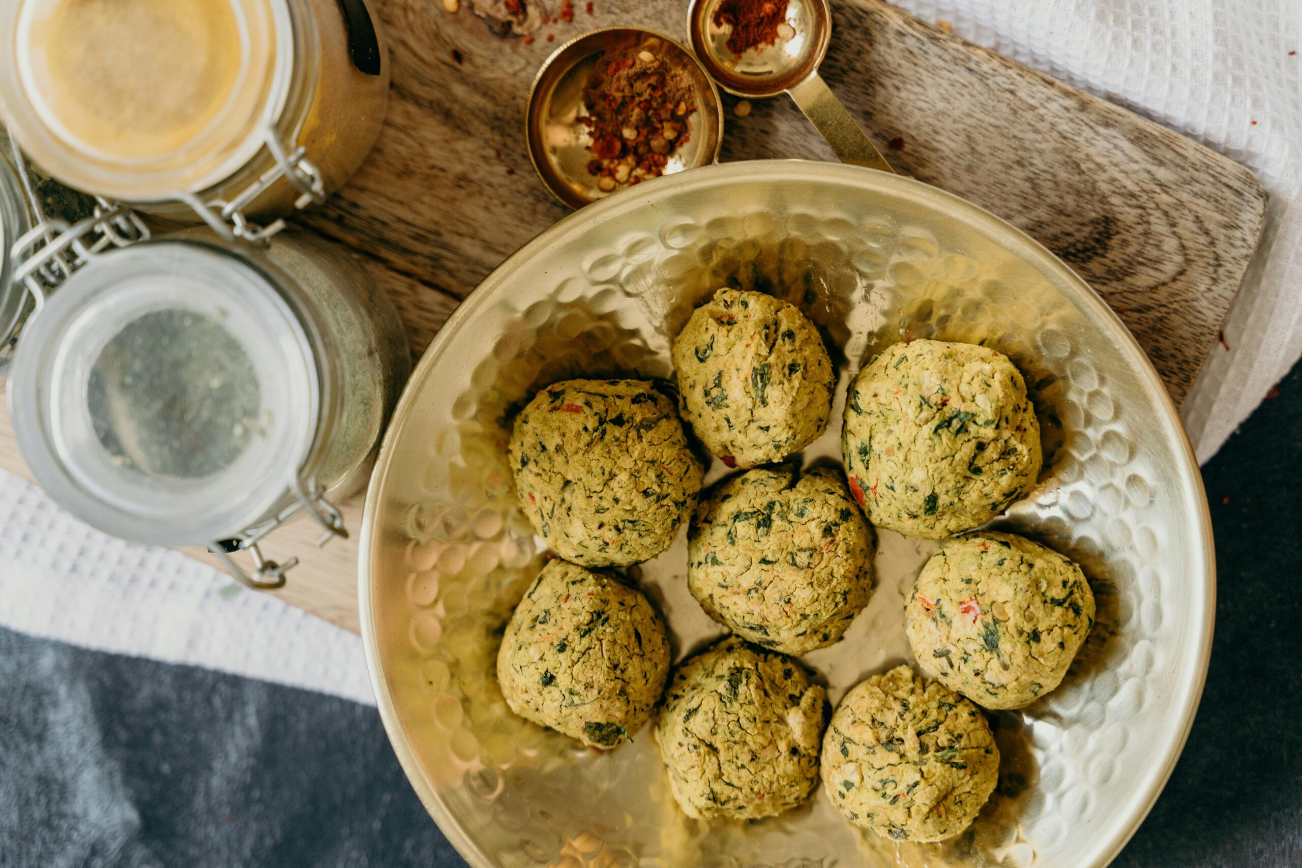 Top view of freshly made vegan falafel on a bronze plate, showcasing a healthy and organic meal option.