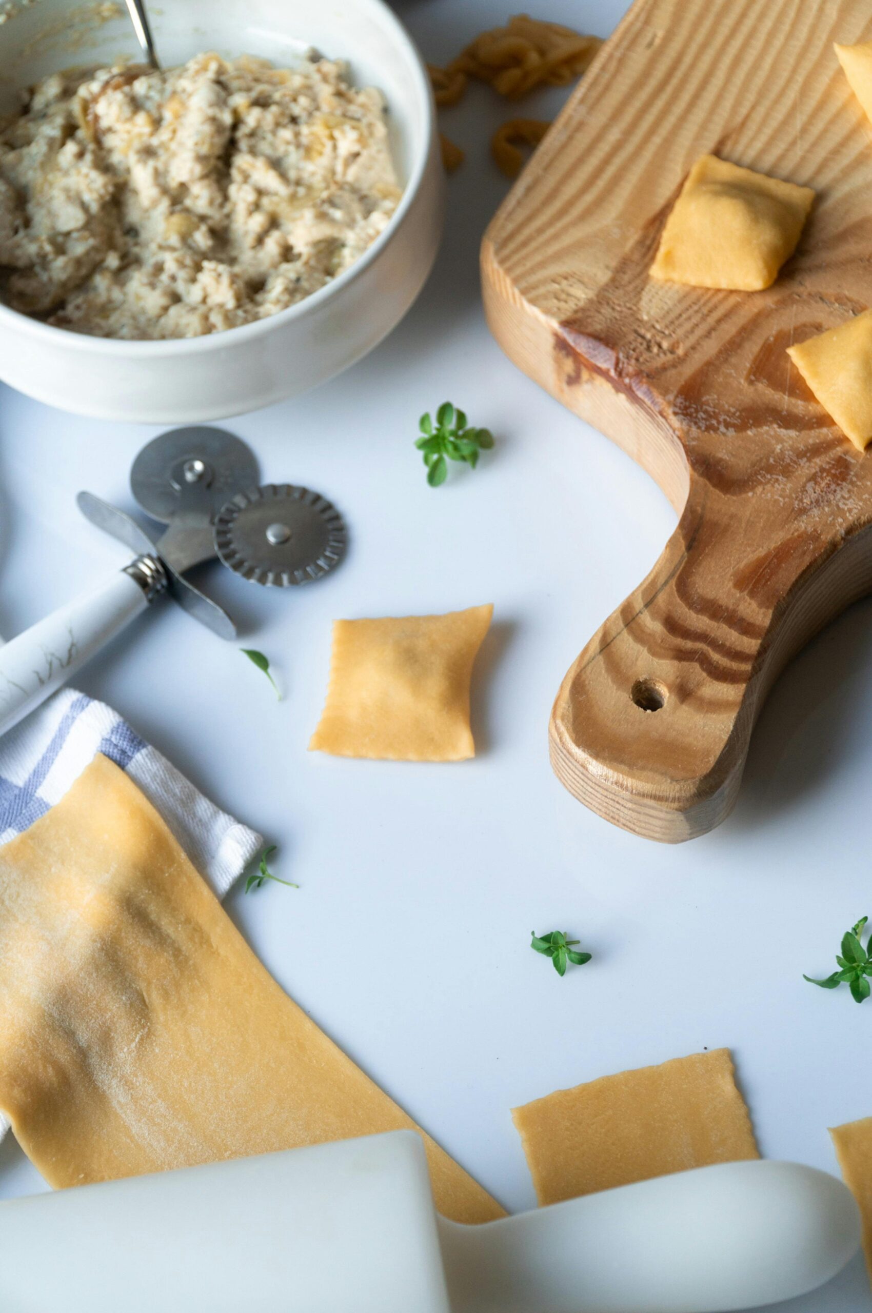 Top view of homemade ravioli preparation with ricotta filling on a wooden board.